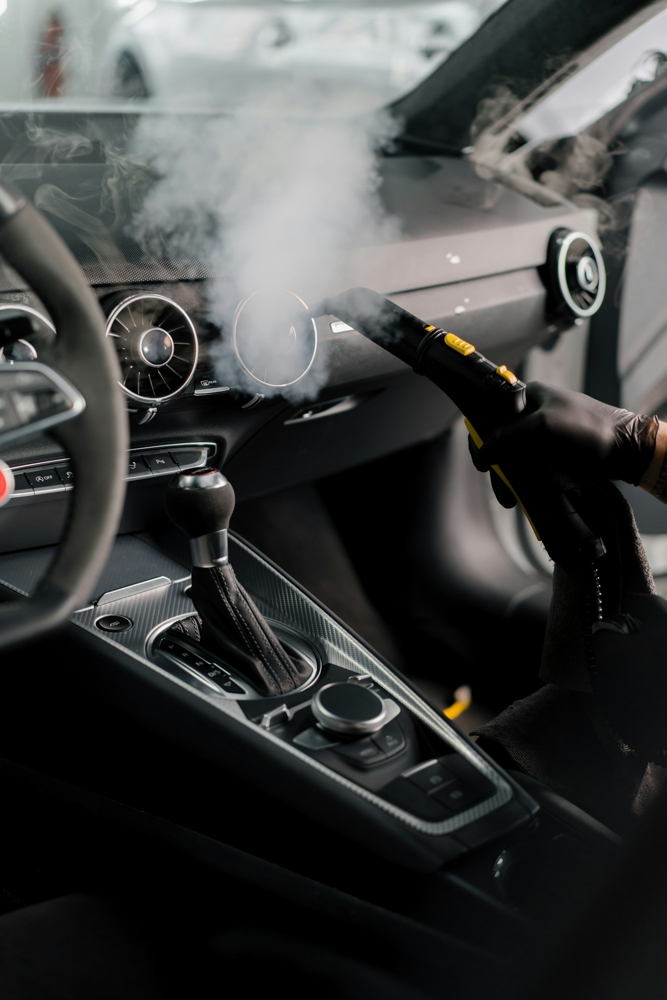 The detailing master cleans the car interior with a hot steam cleaner Cleaning the car interior